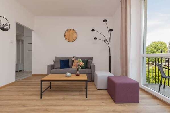 Relax in the stylish living area with a comfortable sofa and cosy decor.