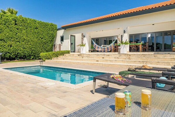 The large swimming pool is nestled in the private backyard.
The pool size is 3 x 6 meters. There is a shallow area and a deeper area. 5.5 feet the deepest part.