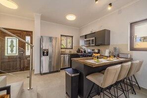 This complete kitchen is suitable for prepping quick meals for your family. There is a fridge, a stove, an oven, a microwave, a coffee maker, and more.
