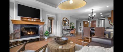 Living Room Area with Electric Fireplace and TV.  Deck Access from Living room