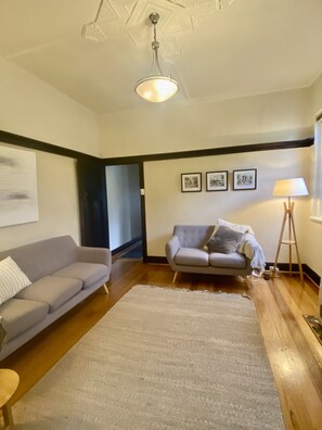 Cozy loungeroom - 2 couches, soft lighting, TV, coffee tables, heat/cool system