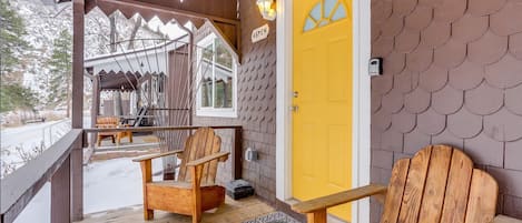 The yellow door on your cabin welcomes you and invites you into the cozy space