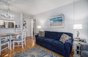 living room. dining area with kitchen in the background
