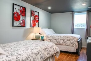 Lower-level bedroom with one twin and one full bed.