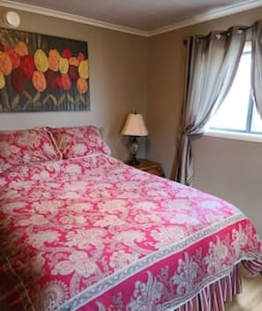 Main level bedroom with a queen bed.