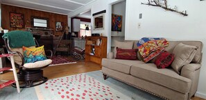 Welcome!  Living area with loveseat looking out to the river