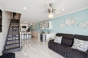 view of main floor. Recliner couch, liquor bar with wine fridge.