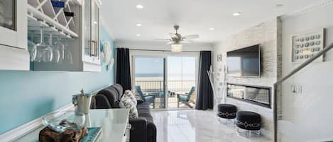 Living room with full ocean view out balcony window. 