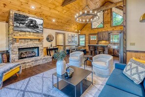 Rustic modern interior design. Watch the 65" TV above the indoor fireplace.