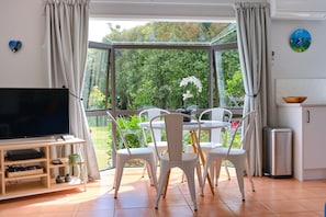 Lovely area to dine, garden view of orange trees.  32 inch smart TV.