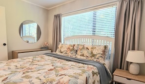 Main bedroom with comfy queen bed, draws and closet space