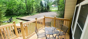Cozy A Frame of Mind front porch with small table to enjoy your morning coffee near Red River Gorge.