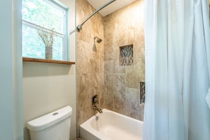 Full bathroom with shower and comfy bathtub