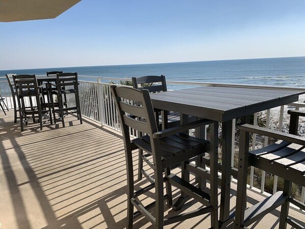 Large Balcony which includes 2 Bar height tables & 8 bar height chairs.  Spectacular ocean view!  See & hear the waves break. 