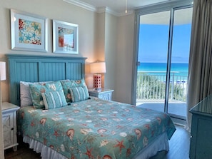 Guest Bedroom with Queen bed and slider leading out to balcony. Includes bathroom with bathtub & shower.