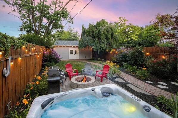 Relax in the hot tub and enjoy the serene back yard
