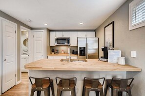 Spacious kitchen with a butcher block island, bar seating, and all the essentials for cooking and dining in comfort.





