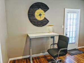 Stay productive with this electric sit/stand desk and ergonomic chair, perfect for remote work in a quiet and comfortable setting.
