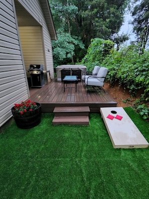 Enjoy the brand new hot tub, BBQ, cornhole, and patio seating