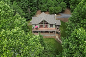 Rear of home faces lake, upper and lower decks.