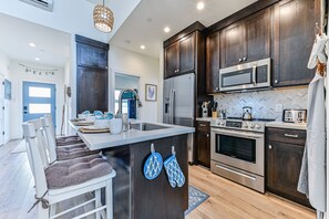 The modern kitchen with quartz countertops and all of the pots, pans and essentials you need to make delicious meals.  