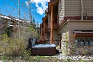 Private hot tub on first level with deck above that has a grill and a small table perfect for morning coffee.