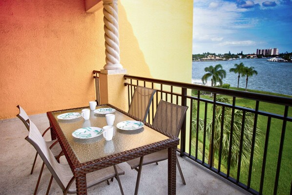 Private waterfront balcony with outdoor dining.