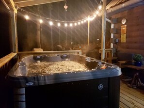 The hot tub is just outside the back door and right next to the firepit. 