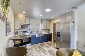 kitchen with full sized refrigerator/freezer, stove, oven, microwave & farm sink