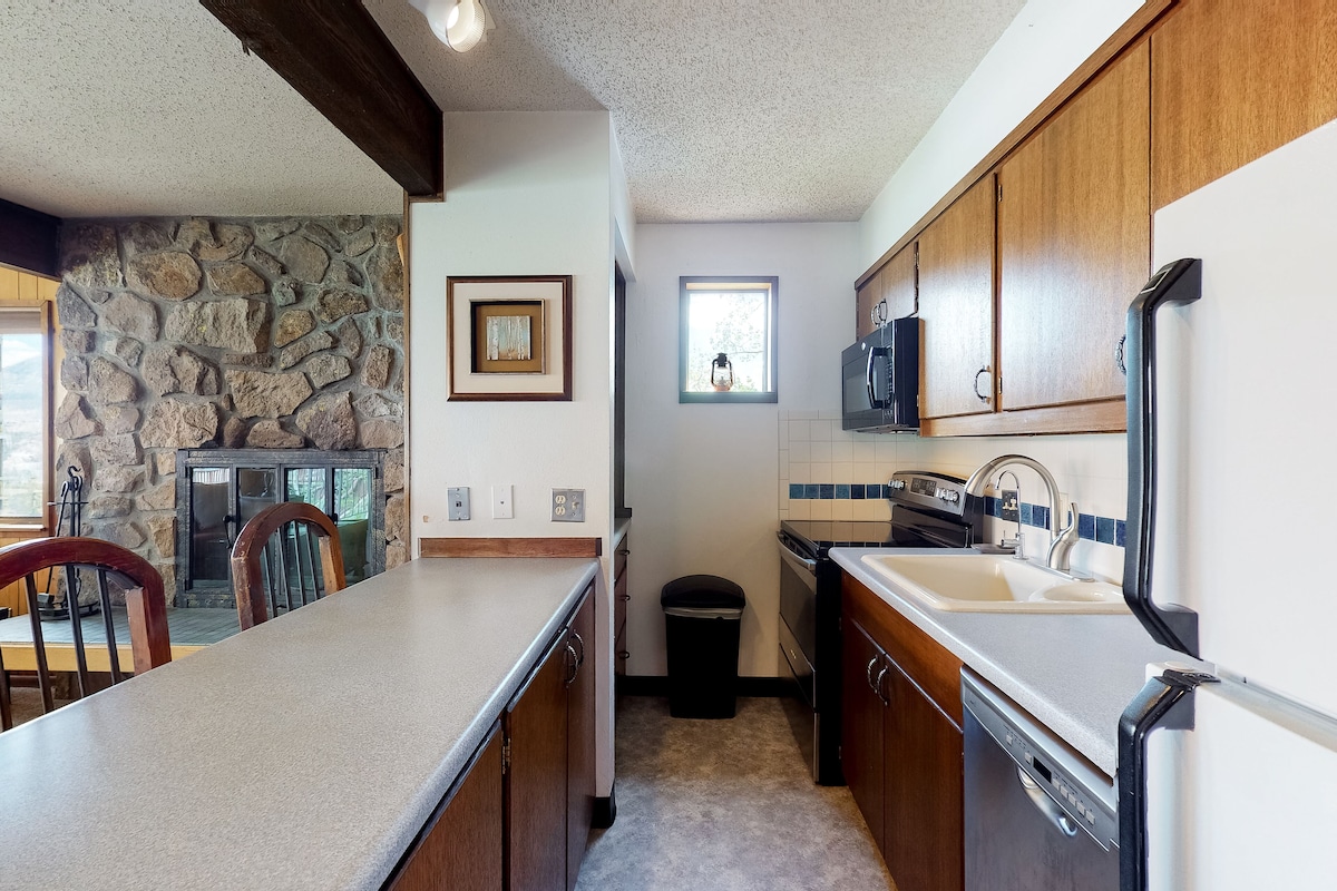 Mountain view condo with ski-in/out access, pool, deck & fireplace