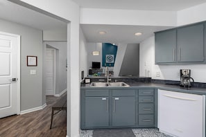 Kitchen looking into front hallway and living room spaces