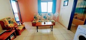 Lounge area, leading to balcony.
