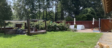 The fenced in yard includes the pool and a hot tub, and a door out to the meadow