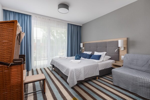 Relax in the stylish living area with a comfortable bed and modern decor.