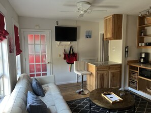 Living area with leather sofa, HDVT, and full kitchen
