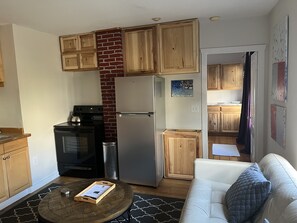 Living area with leather sofa, HDVT, and full kitchen