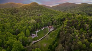 Aerial view showcasing the private setting of this gorgeous cabin snuggled in the mountains.