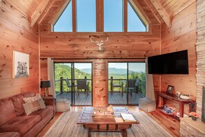 Welcome to 50 Mile View! Enjoy lounging in the living room or on the deck and soak in that view.