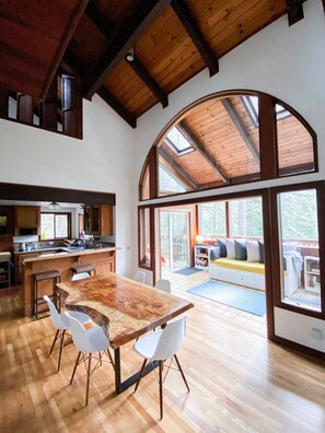 Dining area, Kitchen peninsula, and Sunroom and deck beyond