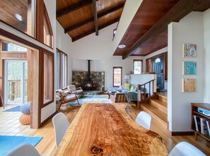 Living-Dining areas with lofted ceiling, fireplace and custom-made dining table