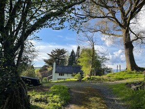 Garden cottage on approach by car to open parking