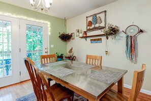 Dining on main floor with french doors leading out to side deck.