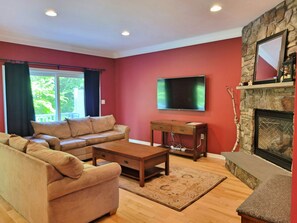 Living area with fireplace, TV and deck slider