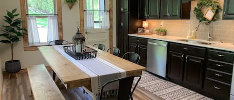 Fully stocked Kitchen with ample seating around Farmhouse Table