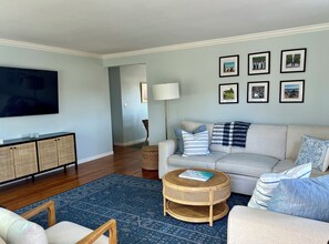 Living room with large sectional couch and big screen tv.