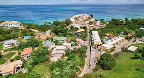 Drone view with property in the foreground and  close proximity of turquoise sea