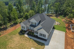 Shot of the house and the lake - you can see our fire pit as well!