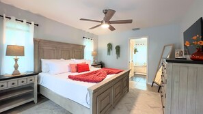 The 1st Bedroom suite features a king bed with premium linens, an ensuite bathroom for privacy, and a spacious, tranquil retreat designed for ultimate relaxation and comfort.