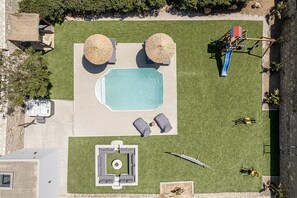 A spacious outdoor area, with pool, jacuzzi, playground and fitness equipment