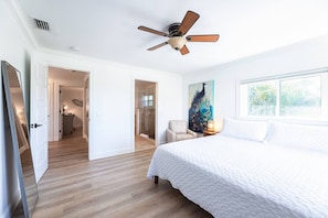 The upstairs master is bright with new hardwood flooring, new King bed, SMART TV, closet, and large bathroom with walk in shower and dual vanity (shared with Queen bedroom).